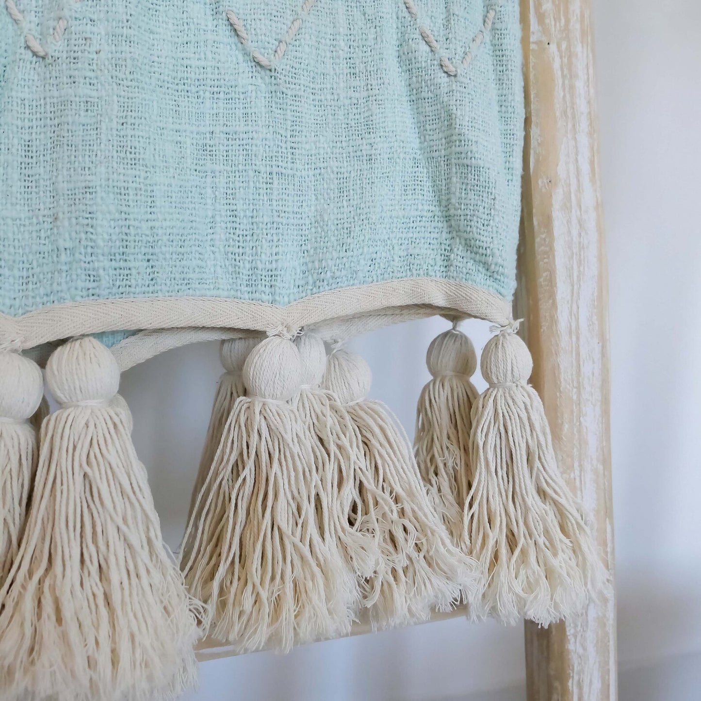 light blue organic throw blanket with pom pom