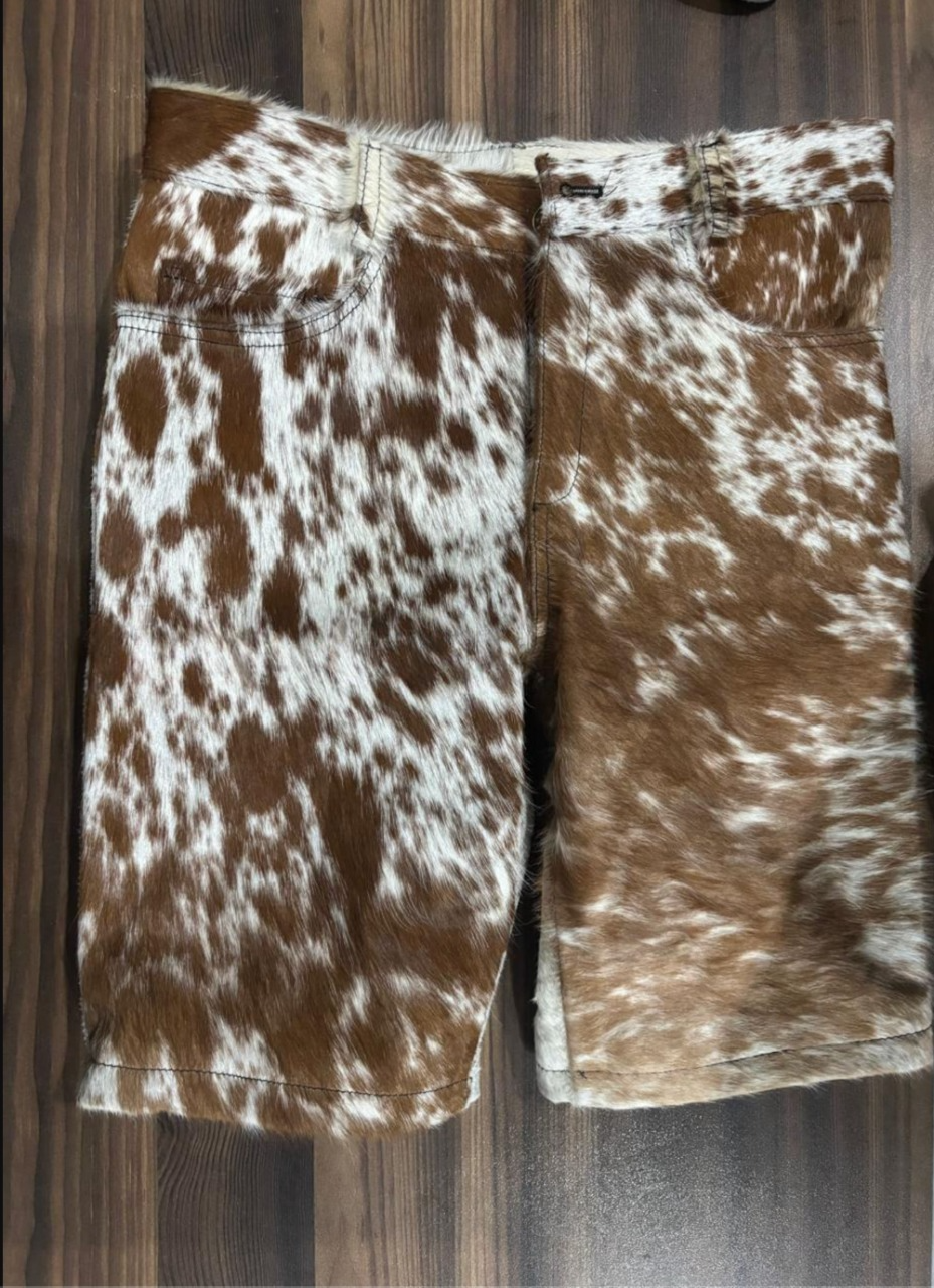 Men’s cowhide shorts made from genuine hair-on leather with brown and white patterns, designed for streetwear appeal and western-inspired styling with a bold silhouette.