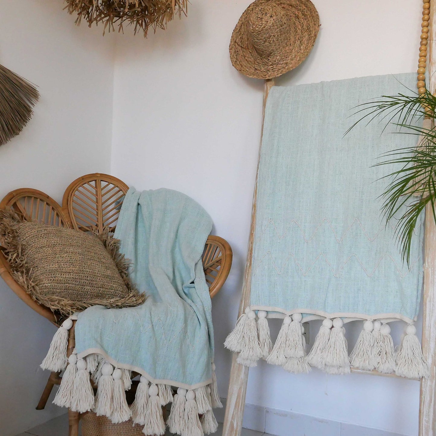 light blue organic throw blanket with pom pom