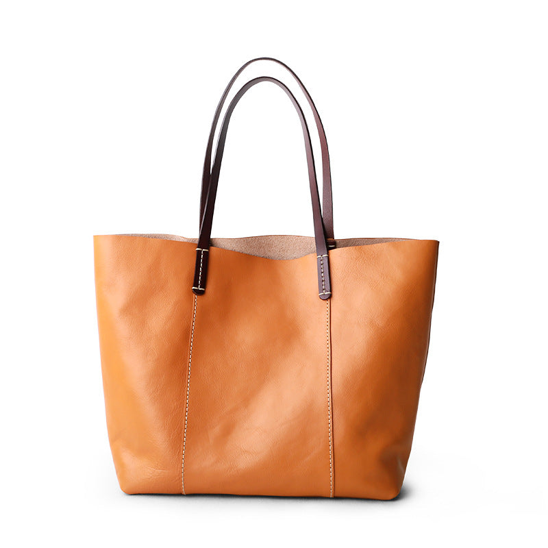 Genuine leather tote bag for women featuring zipper closure, deep interior, and minimalist shape for work, meetings, and daily carry.