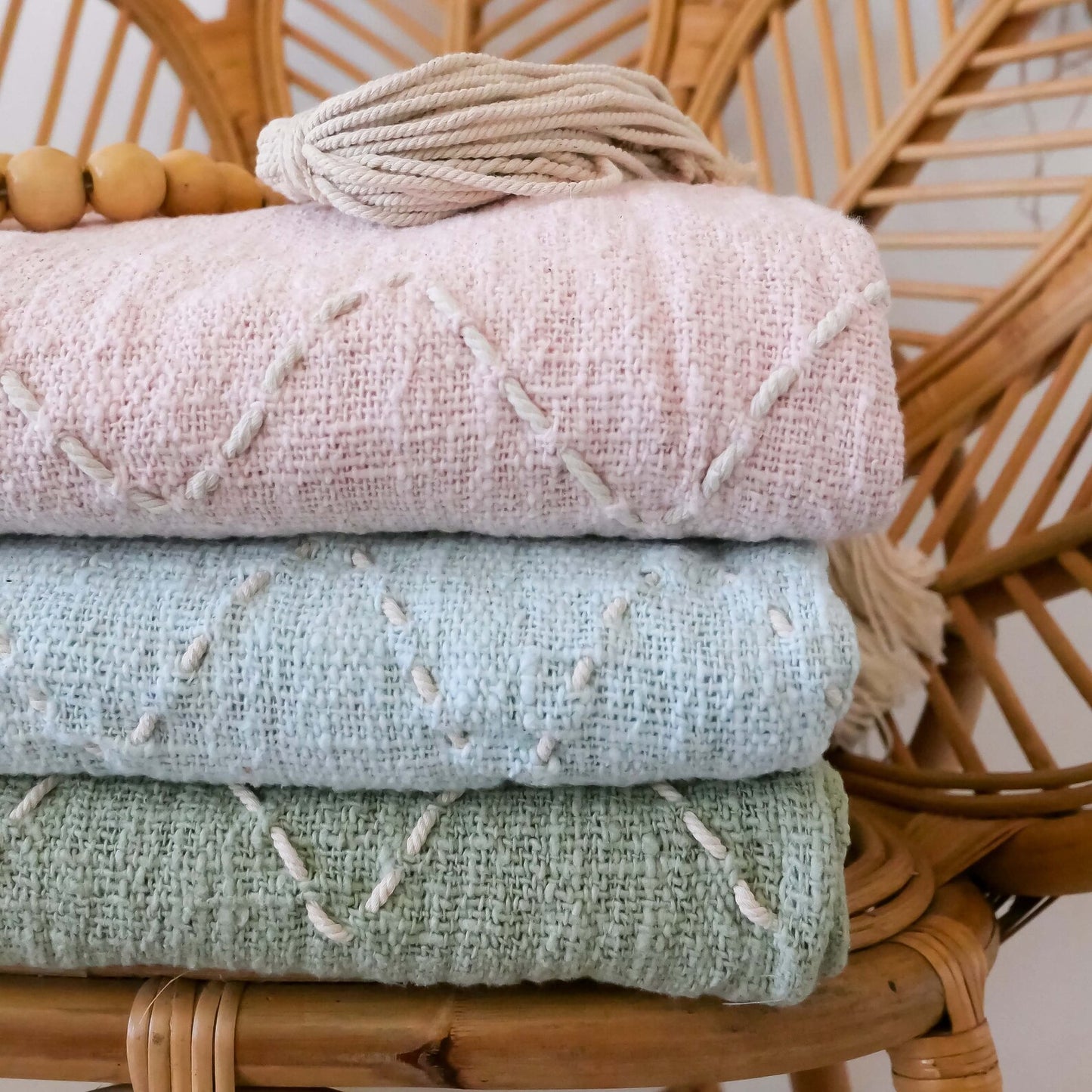 light blue organic throw blanket with pom pom