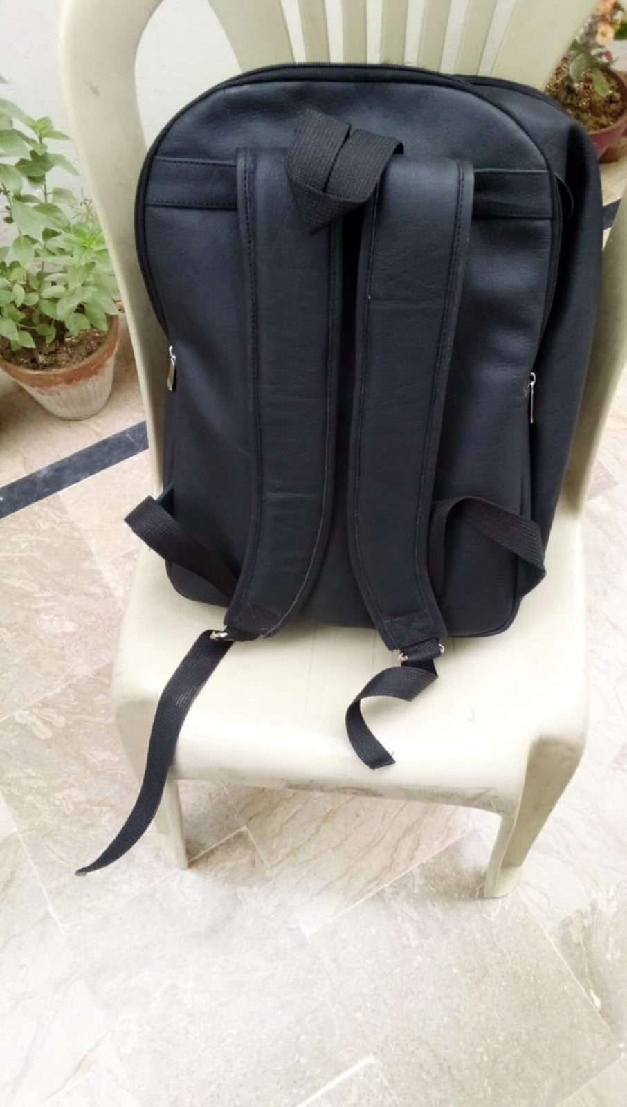 Open cowhide backpack revealing compartments