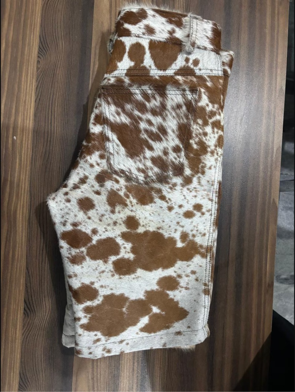 Western rodeo shorts men leather styles need—crafted in real cow skin with speckled patterning, mid-thigh cut, and bold character for standout streetwear appeal.