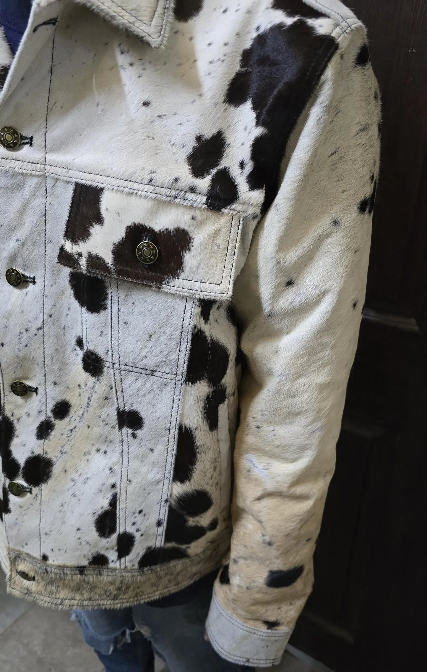 Real cowhide fur jacket for men in a tricolor cow pattern. Tailored cowboy coat designed for rodeo events, ranch fashion, and cow print lovers.