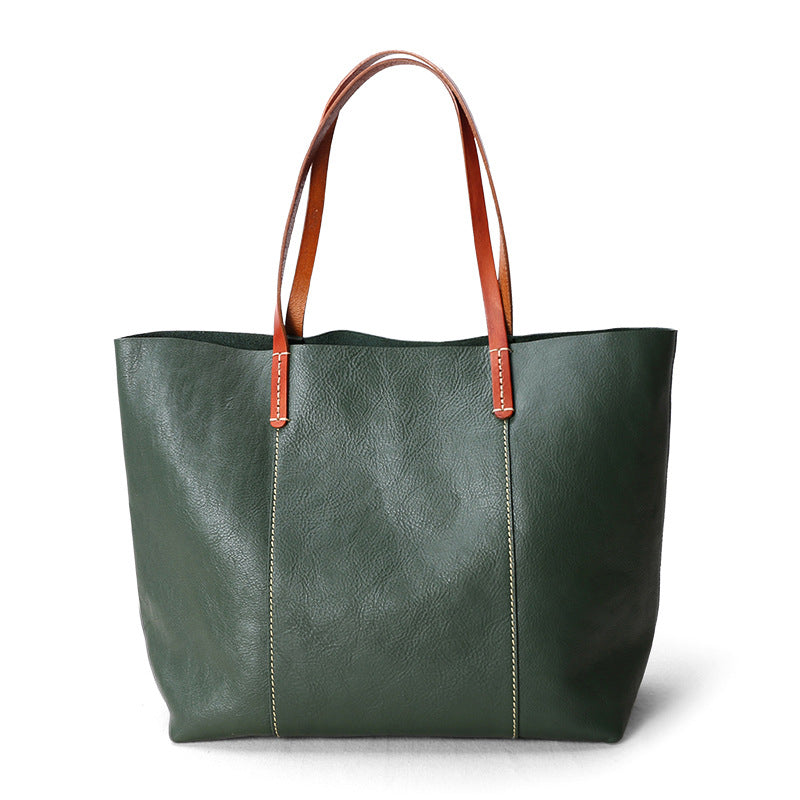 Oversized leather tote purse with inner pockets and top zip, made for women balancing office work and daily life in one bag.