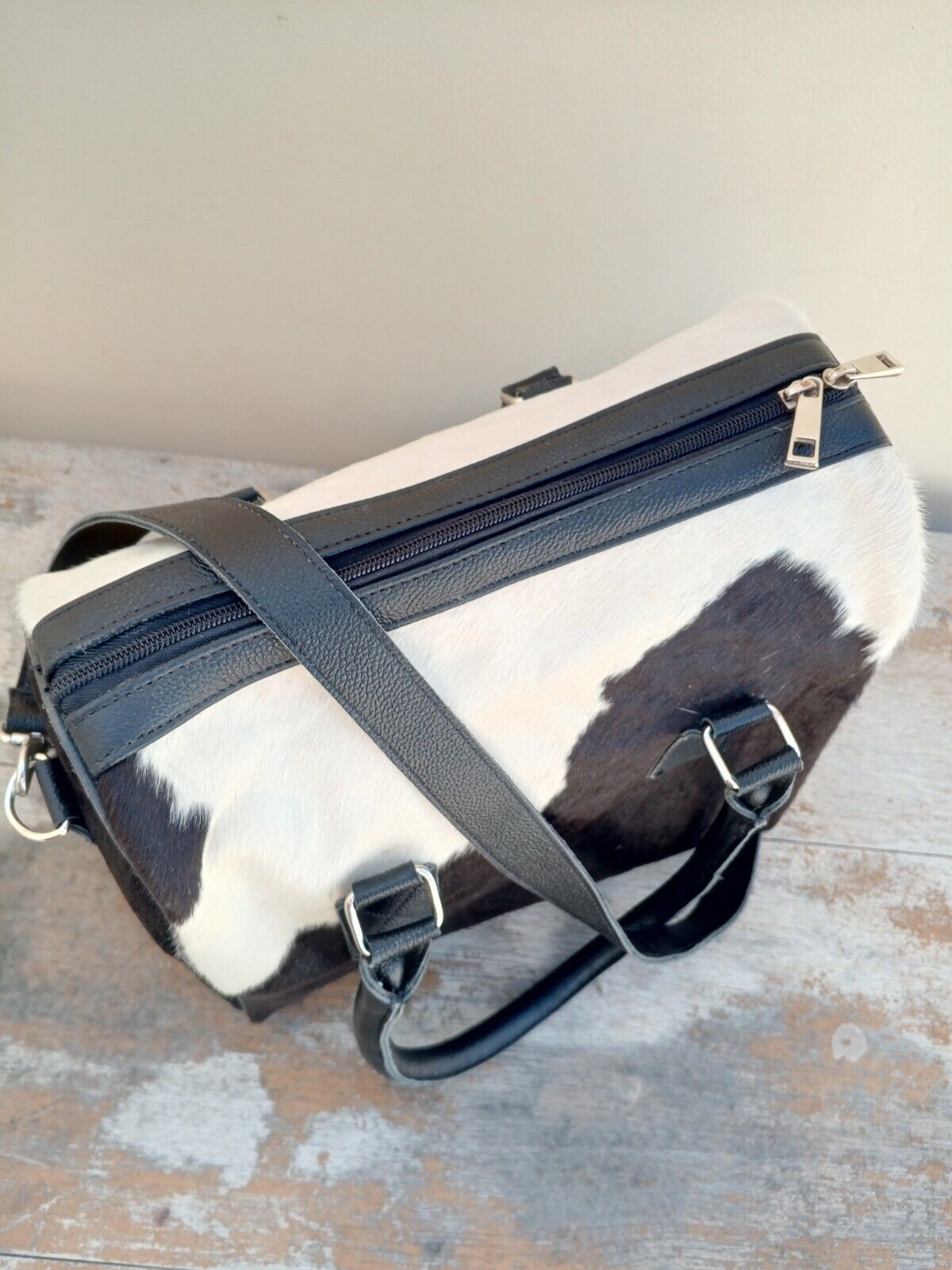 Close-up of a cowhide purse with unique natural patterns.