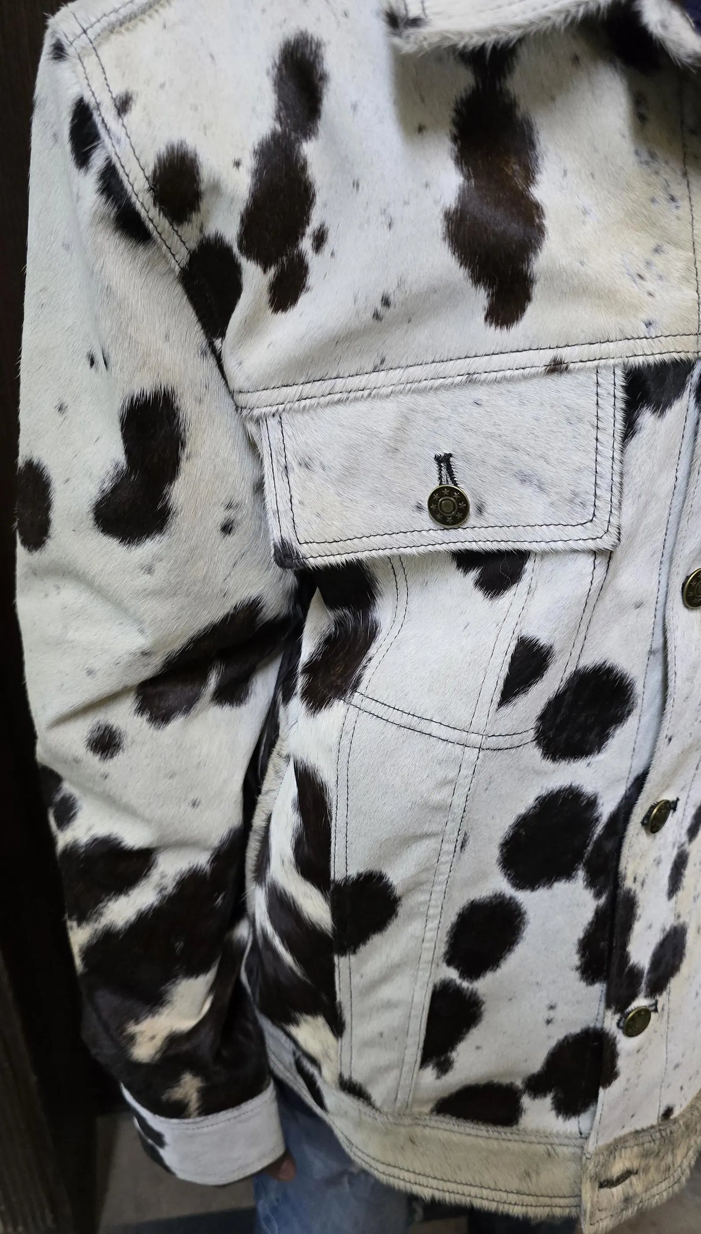 Black and white cowhide jacket for men crafted from real cow skin. Eye-catching fur pattern ideal for western jackets, country wear, or bold casual style.