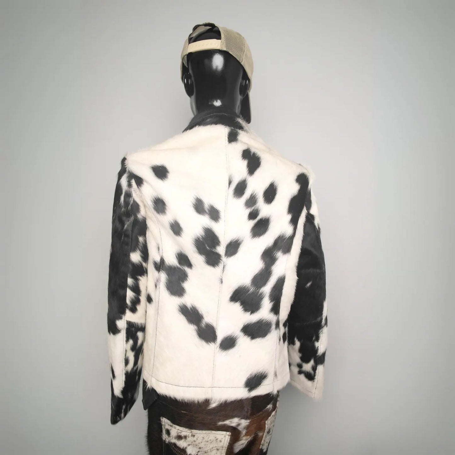 Unisex cowhide fur coat in black and white. Authentic western rodeo jacket, premium quality cow skin design for country living and winter fashion.