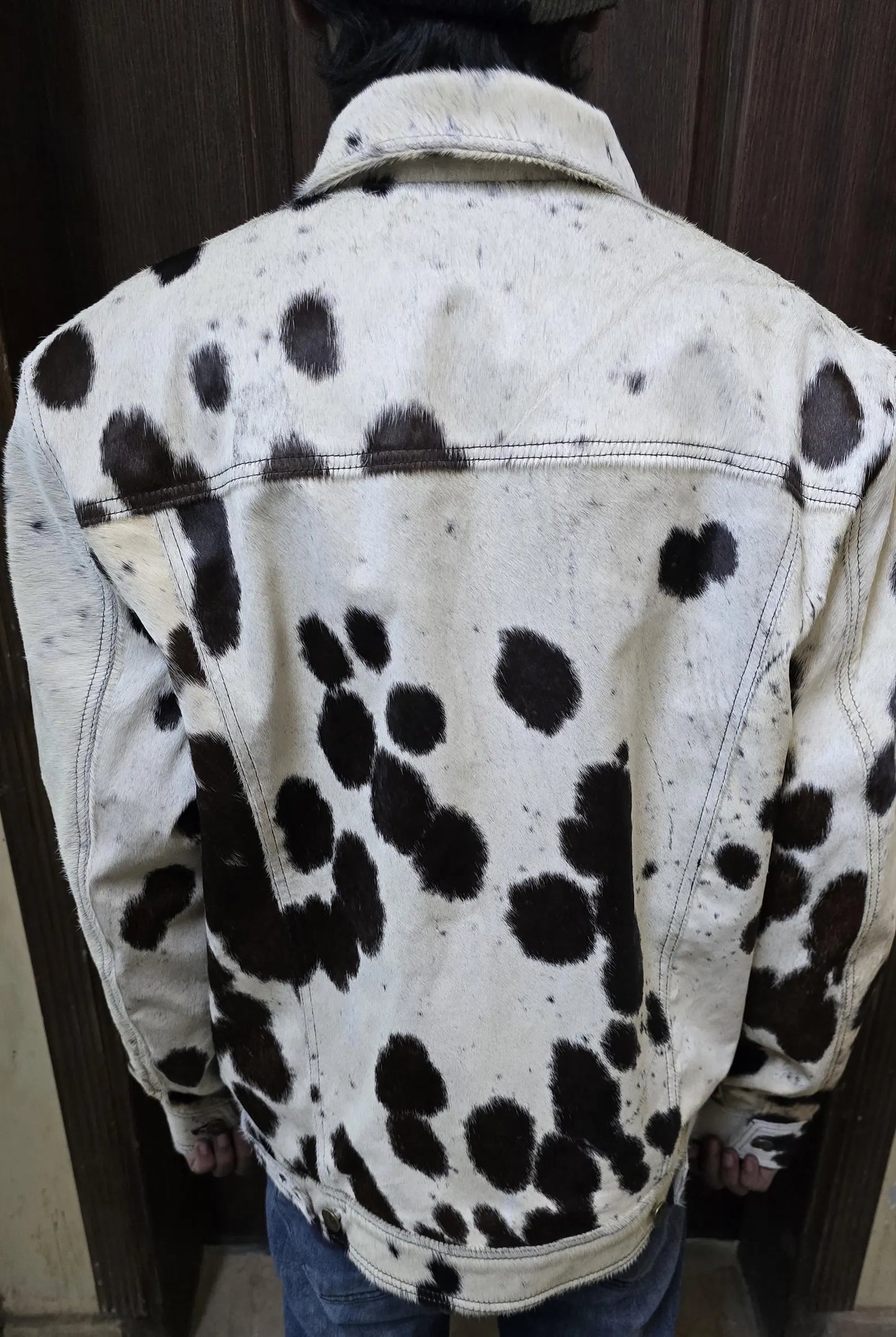 Men’s cowhide jacket with authentic cow print in natural fur. Unique cow fur coat blends cowboy edge with modern outerwear appeal.