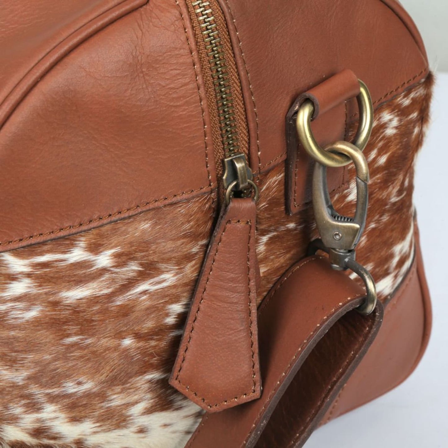 Indulge in opulence with a luxurious cow fur overnight bag, your essential companion for indulgent travels.