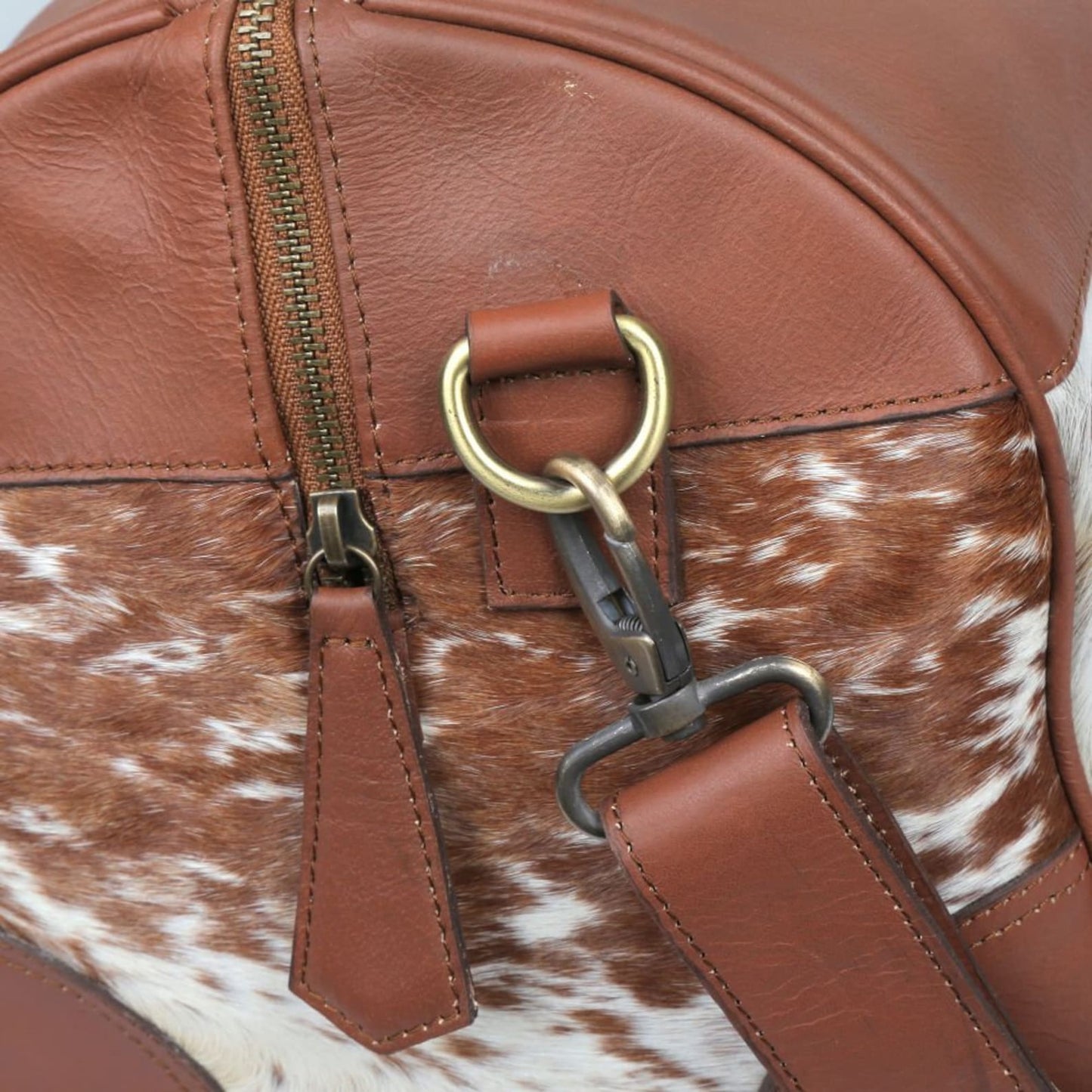 Hit the road in style with a chic cow fur weekender bag, a symbol of sophistication and adventure.