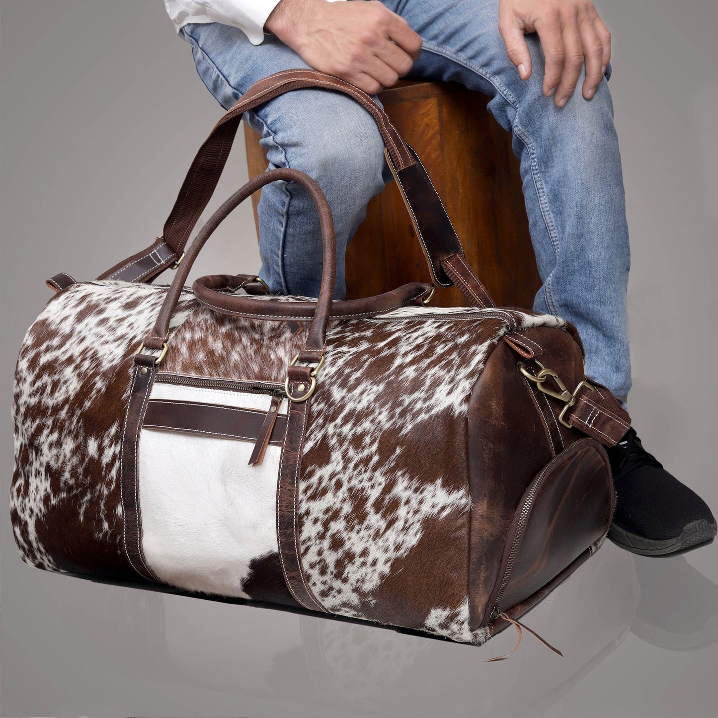 Step into luxury with a sleek cow fur duffle bag, designed to elevate your travel experiences effortlessly.