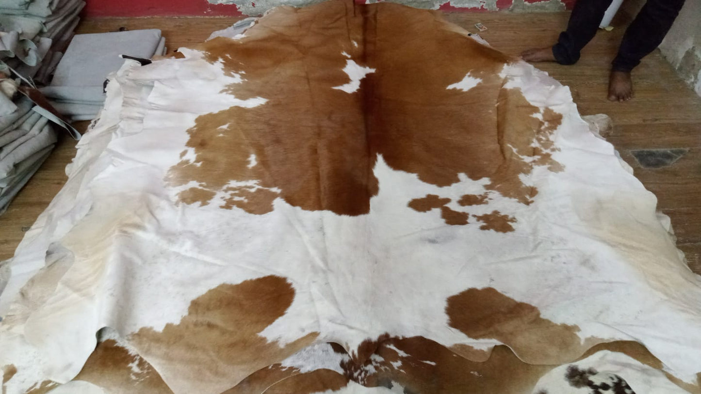 Create a cozy and inviting ambiance with our soft and sumptuous brown and white cowhide rugs, perfect for adding warmth to any space.