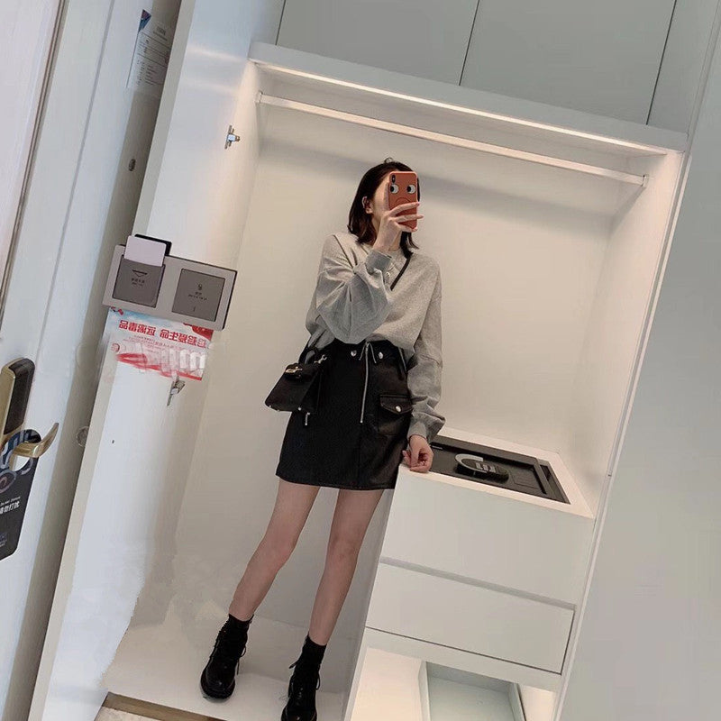 Black leather mini skirt for women with sleek zipper detailing and premium lambskin finish. A fitted silhouette perfect for autumn fashion and night styling.