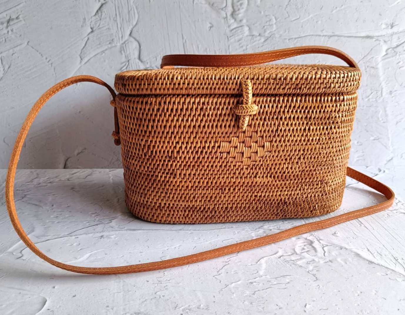 Sun-cured oval woven rattan bag basking under the tropical sun.