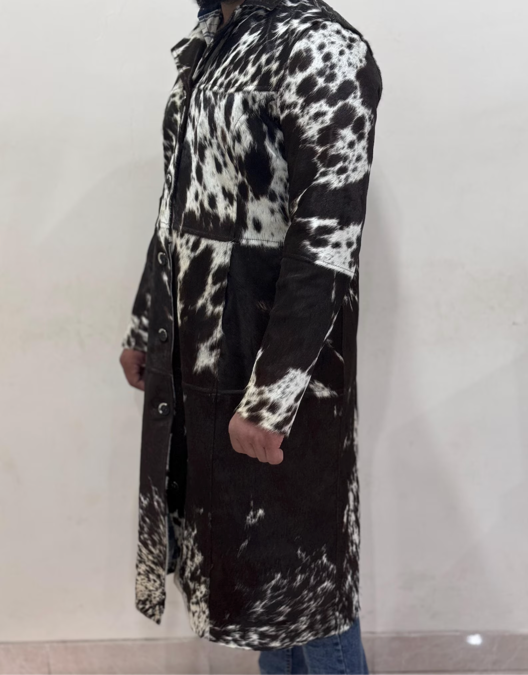 Elevate western outfits with this unisex cowhide trench coat in natural black and white. Designed from hair-on cowhide, this coat brings classic cowboy energy into modern streetwear.
