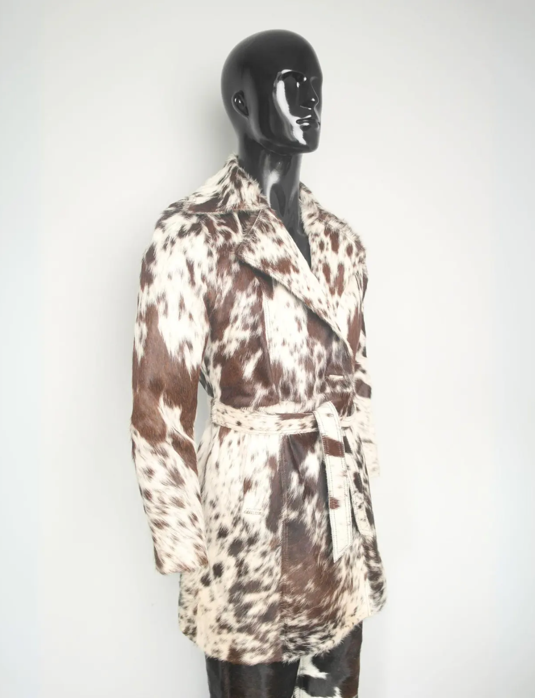 Statement cowhide trench coat crafted from genuine hair-on cowhide leather with adjustable belt, structured shoulders, and standout print.