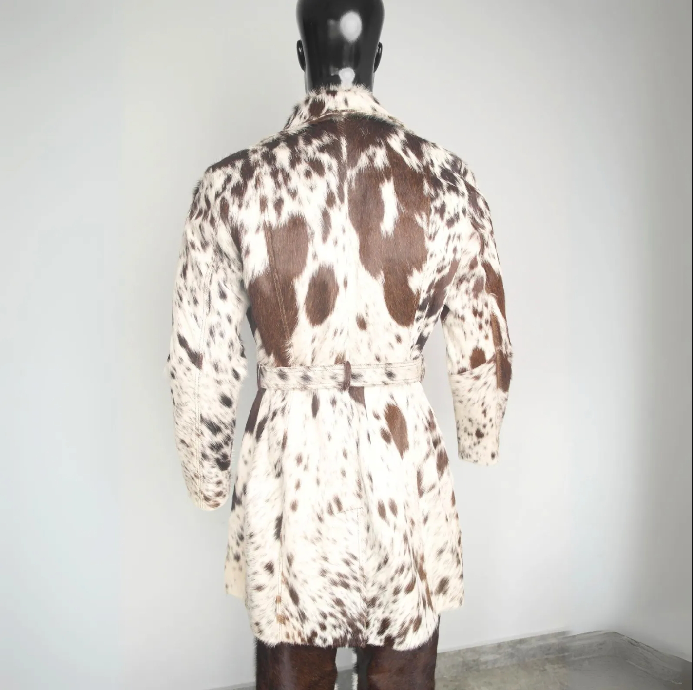 Rare cowhide jacket for women featuring a natural spotted pattern, full-length trench design, and genuine cow skin leather finish.