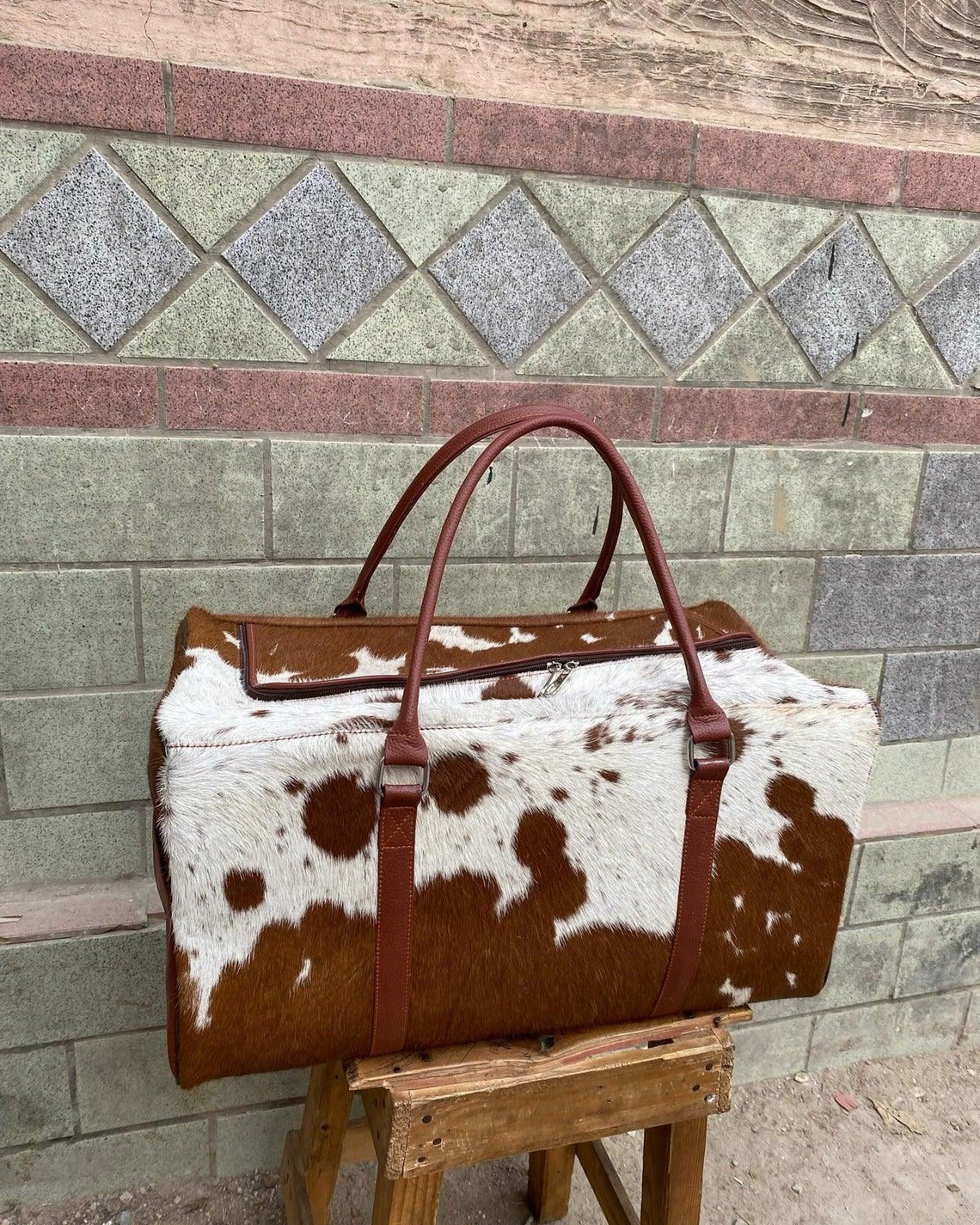 Brown and White Cowhide Duffle Bag for Travel and Overnight Use