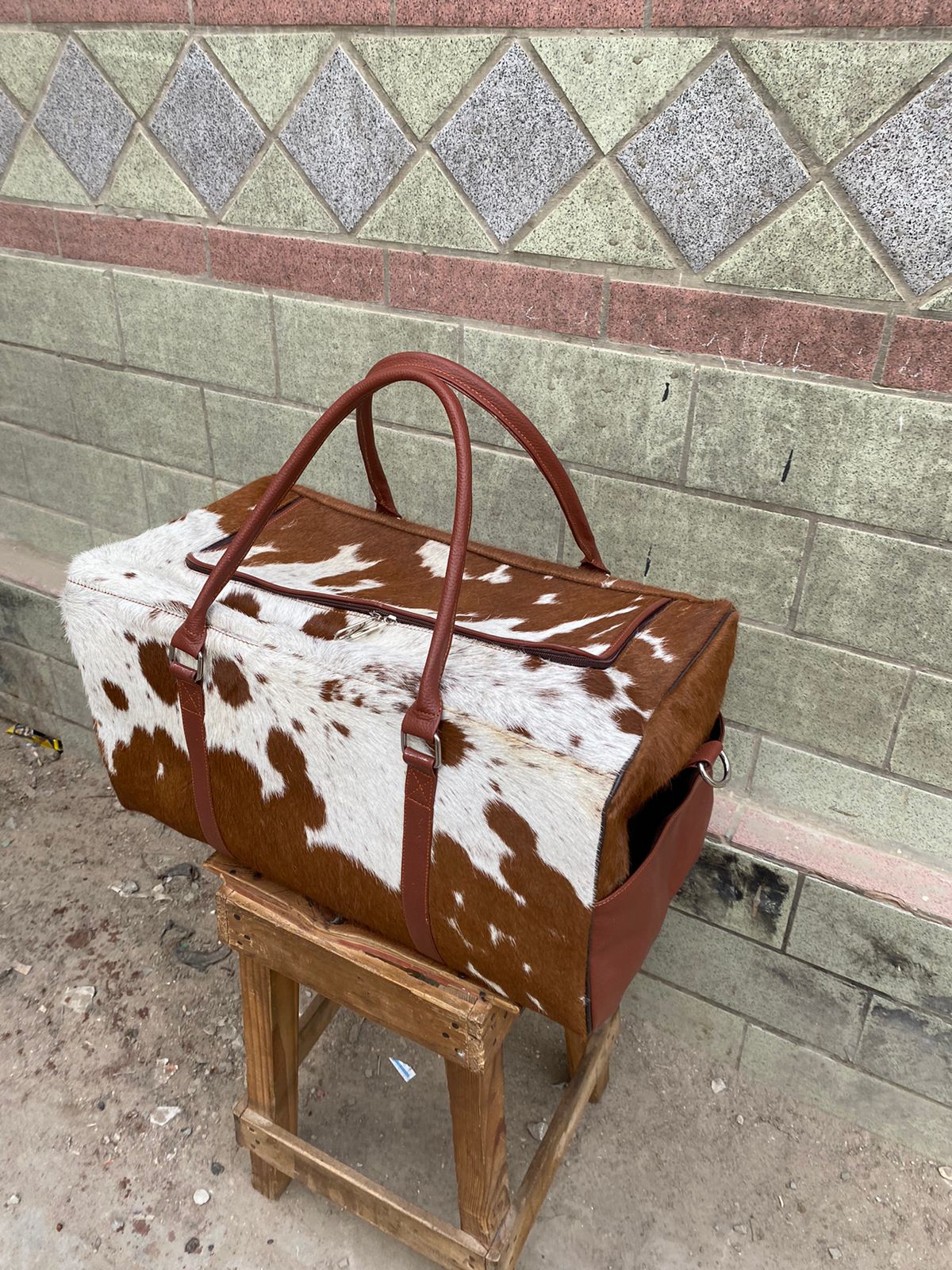 Brown and White Cowhide Duffle Bag for Travel and Overnight Use