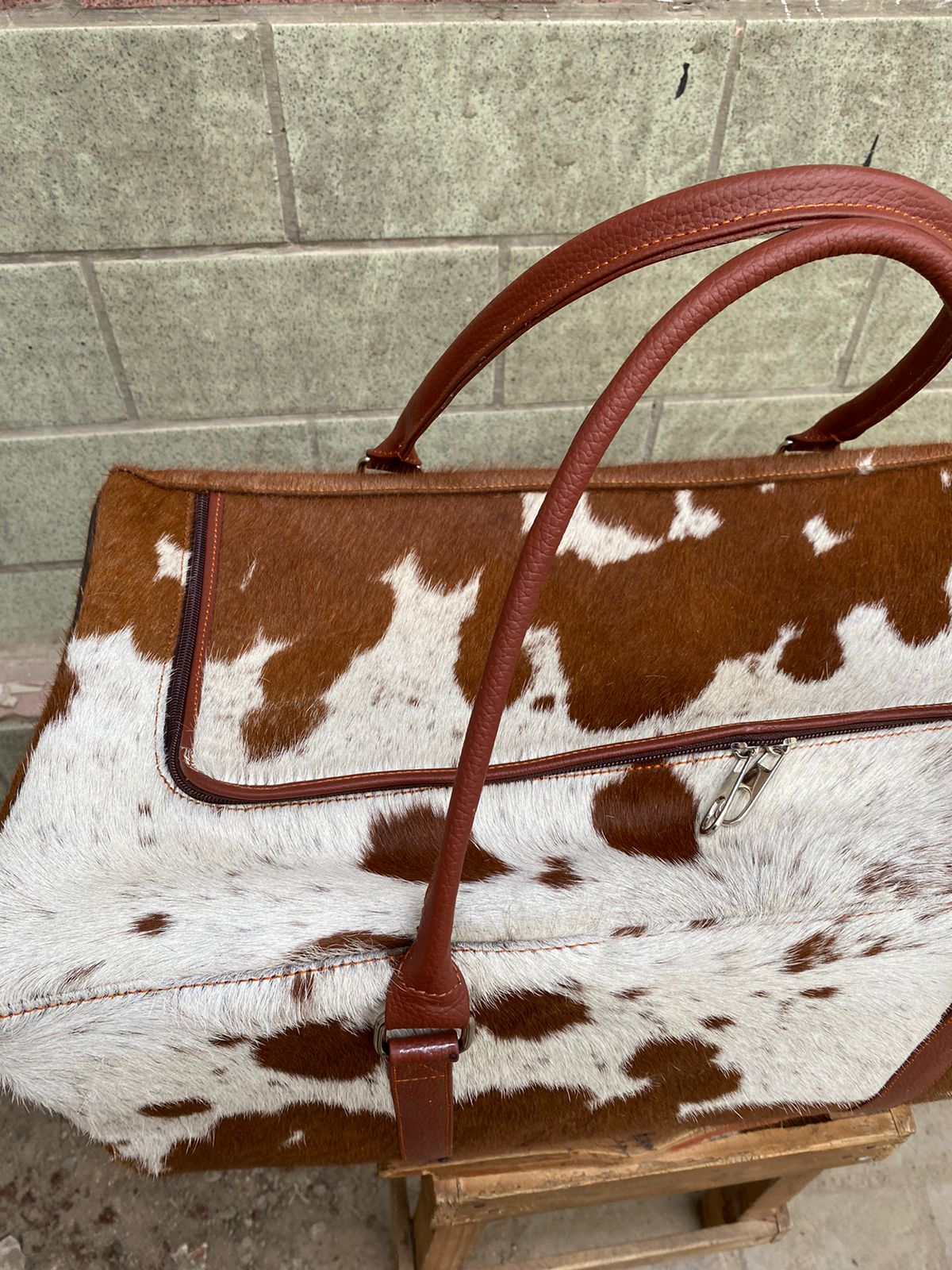 Brown and White Cowhide Duffle Bag for Travel and Overnight Use