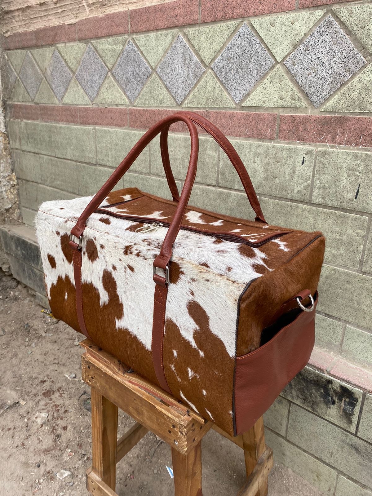 Brown and White Cowhide Duffle Bag for Travel and Overnight Use