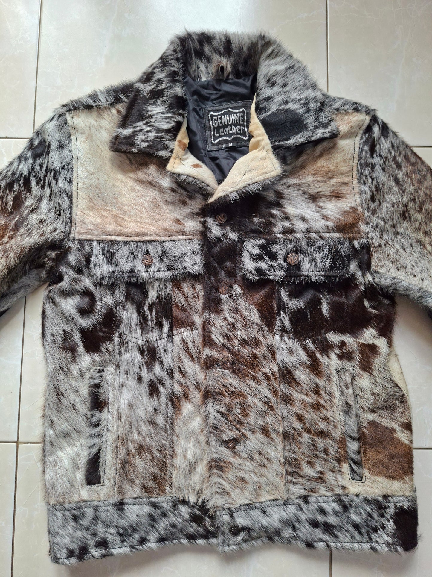 Cow skin jacket for men with spotted cow fur and leather texture. Natural hide pattern makes every piece unique and standout.