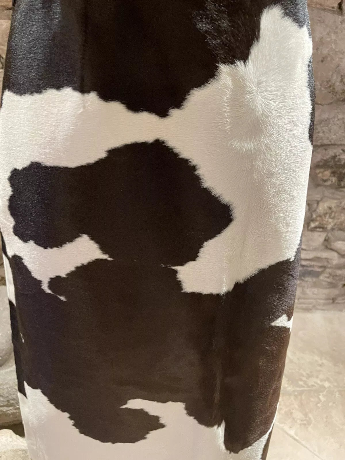 A striking cowhide skirt with black and white contrast, perfect for adding a western edge to cowgirl outfits and rodeo occasions.