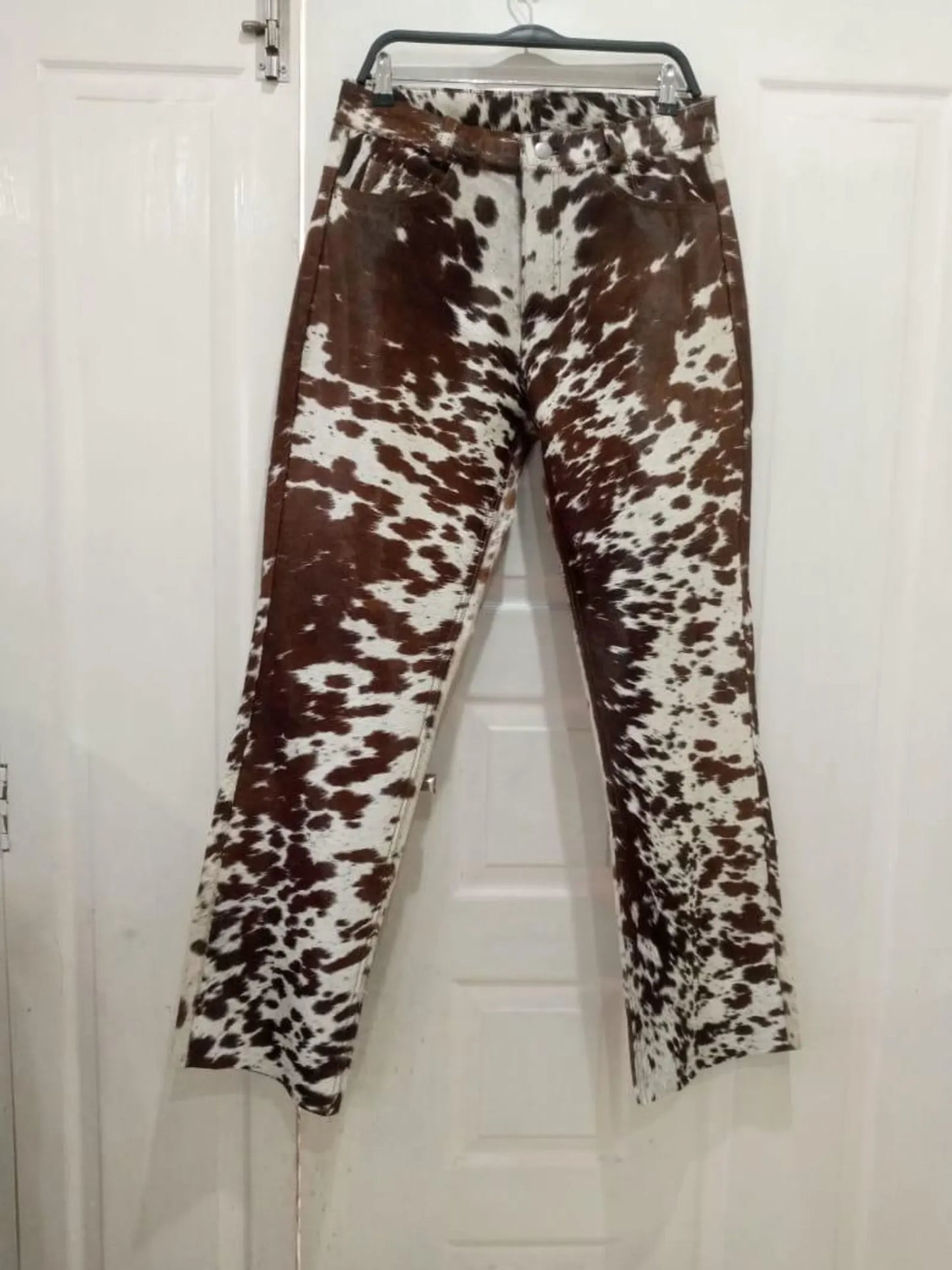 Shop authentic cow print trousers made from genuine cow fur hide. These brown and white cow pants are ideal for men and women with western flair.