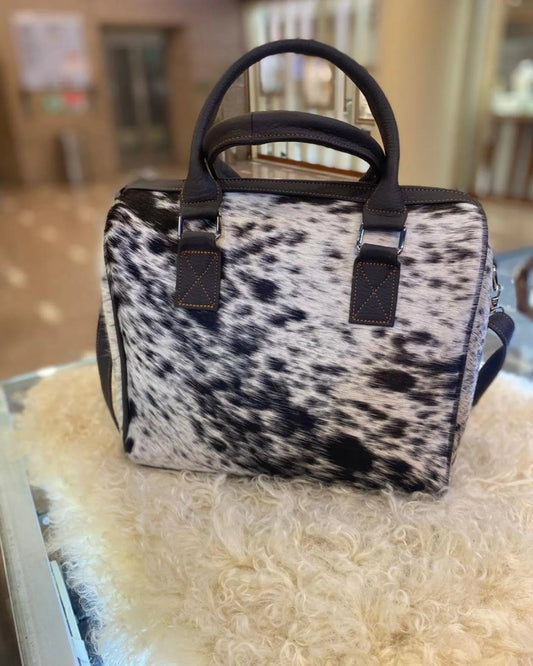 Real cowhide purse with natural spots and leather straps. A standout western handbag for women who love bold accessories.