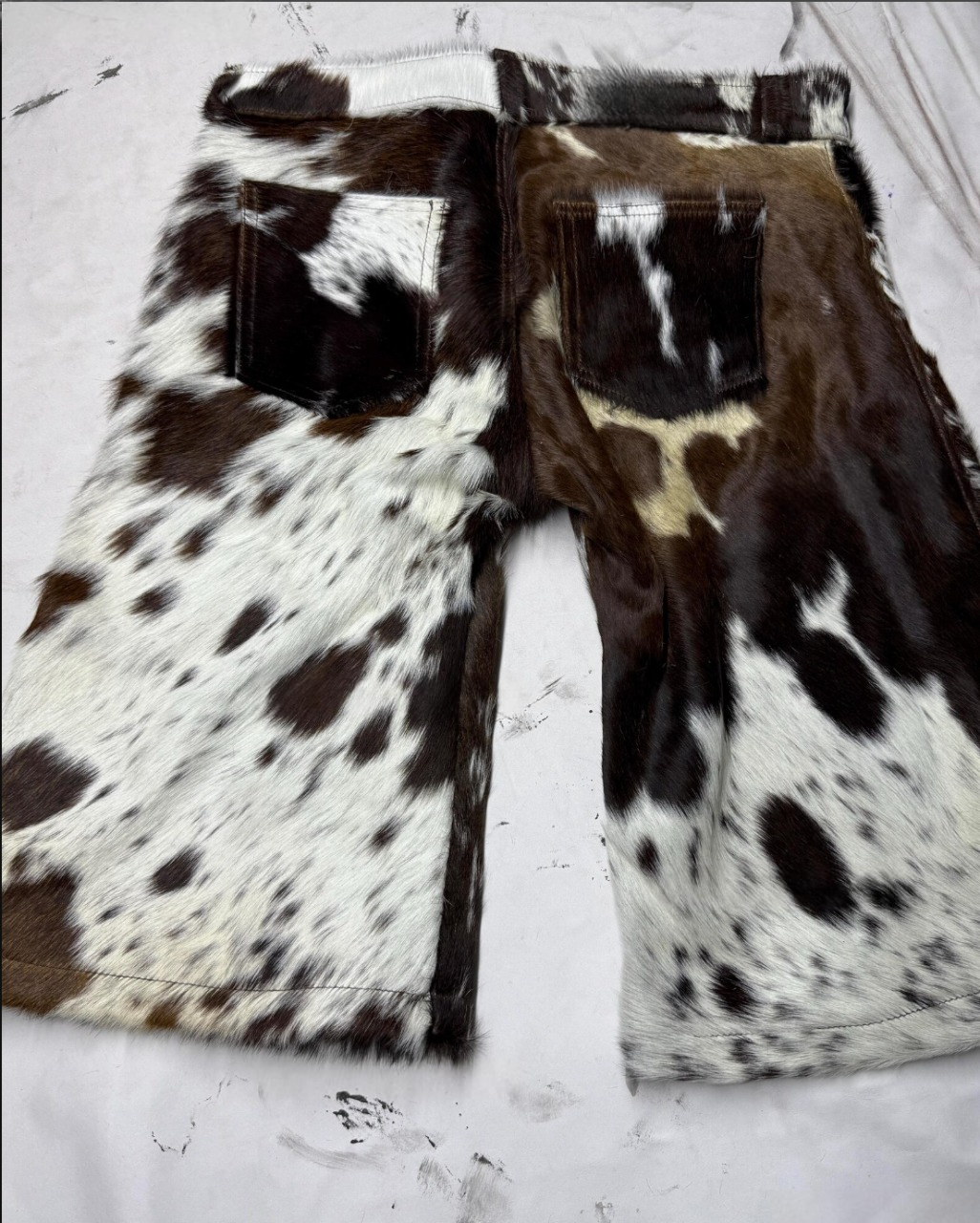 Speckled cowhide leather shorts for men with natural fur finish. Ideal for southern events, western fashion, rodeo styling, and bold cowboy looks.