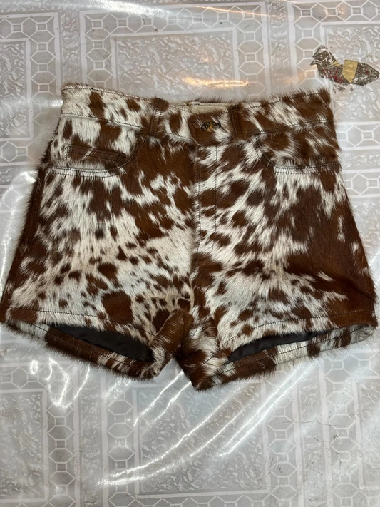 Real cowhide leather shorts with speckled brown fur, perfect for cowgirl outfits, rodeo events, country weddings, and western festivals. Custom fit available.