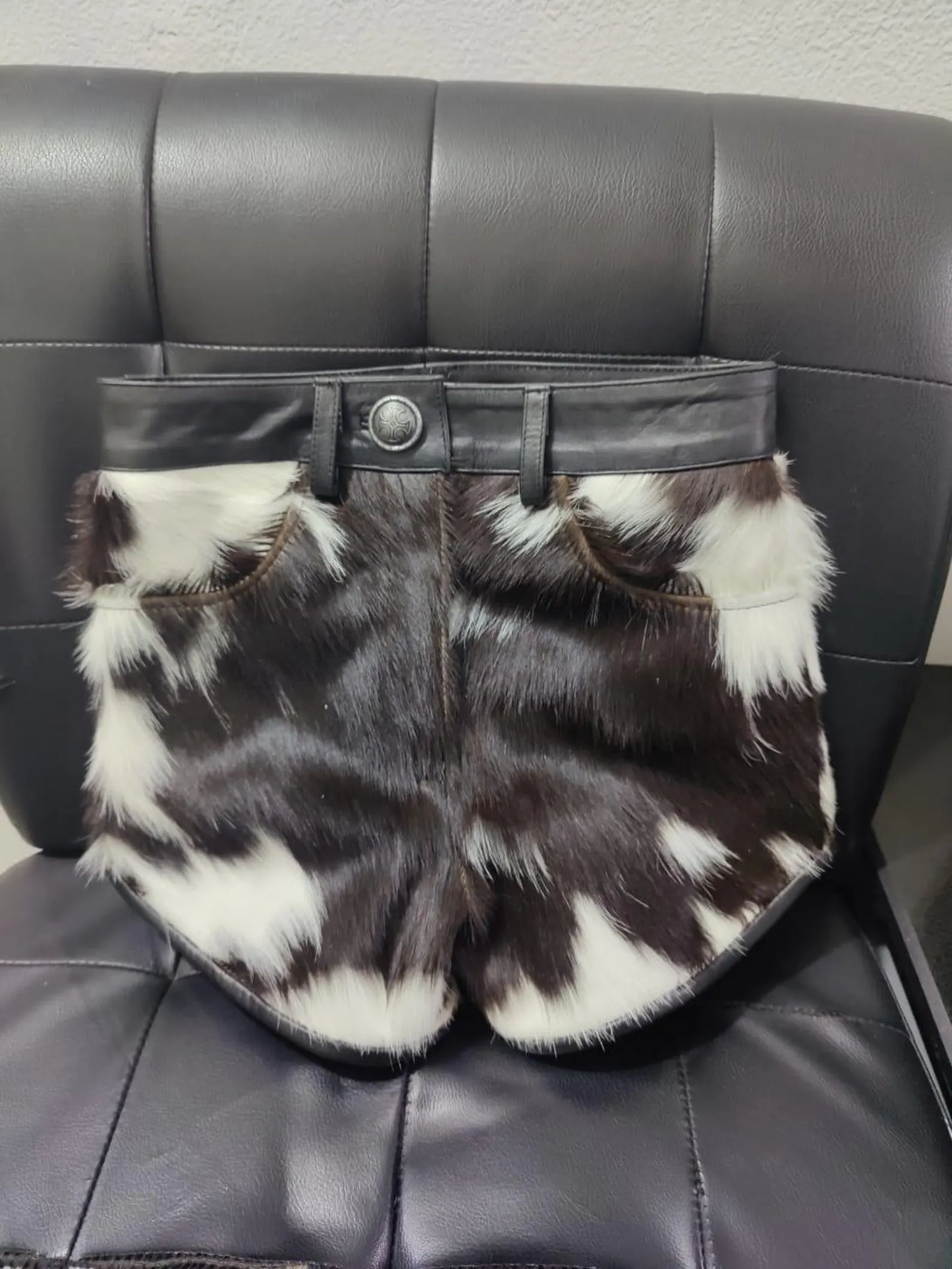 Stand out with real cowhide mini shorts in bold black and white cow print. These women cow skin shorts bring raw Western energy to any streetwear look.