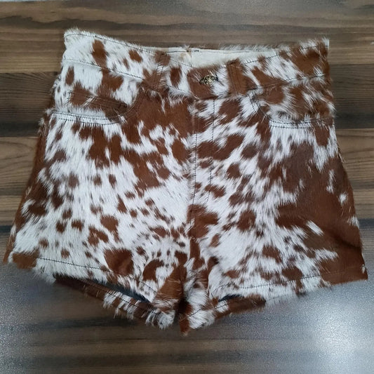 Shop brown and white cow skin shorts made from 100% hair-on leather. These high waisted shorts feature unique hide patterns and classic western design.