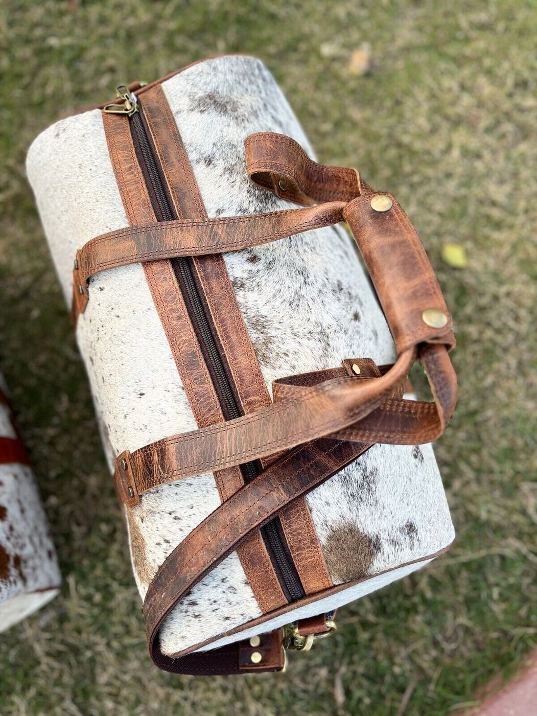 Conquer your adventures with a versatile cow hide duffle bag, your trusted companion for every journey.