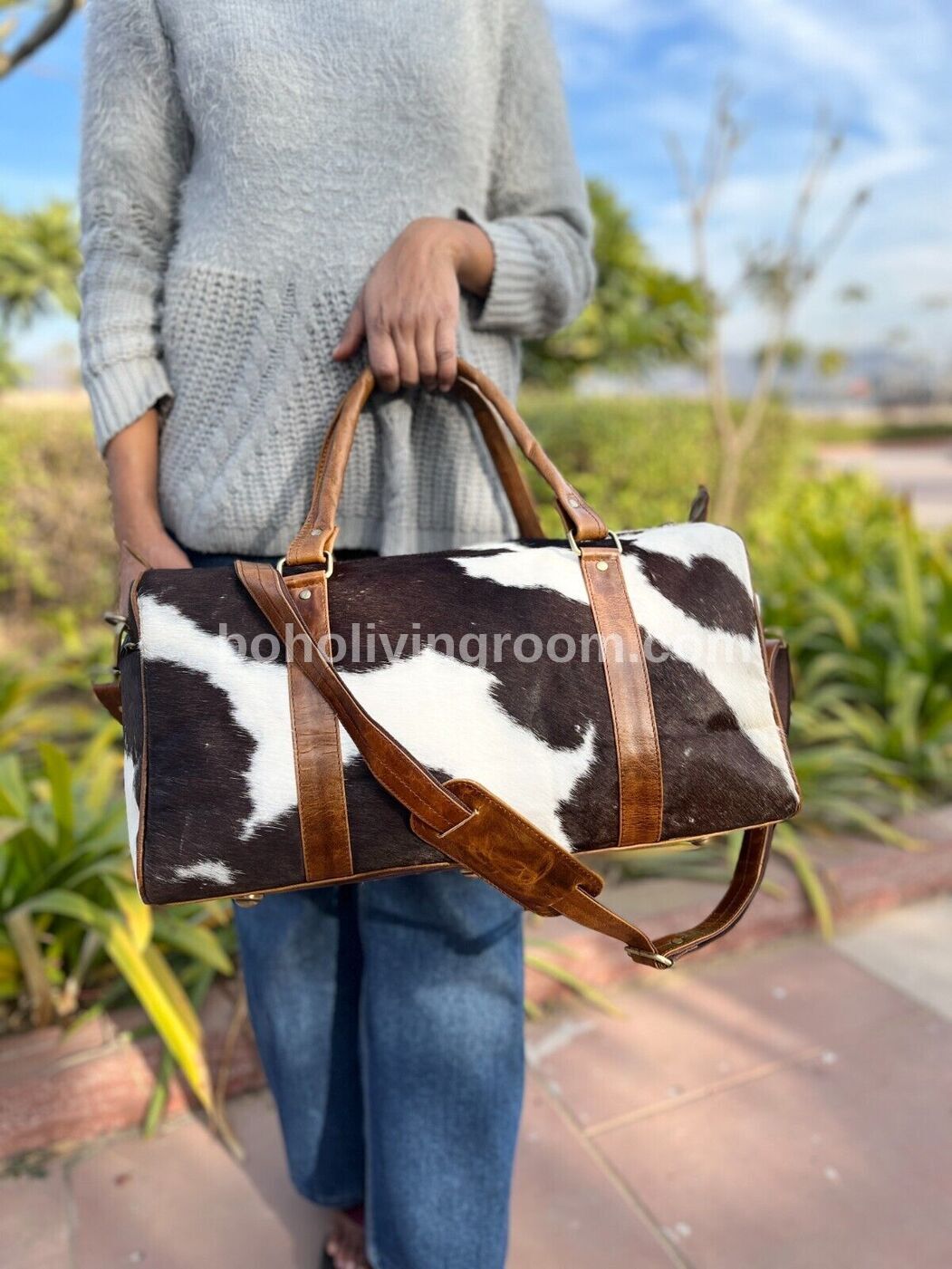 unique cowhide duffel: black, brown, white. travel light, look sharp. weekend getaway or gym essentials, this bag does it all.