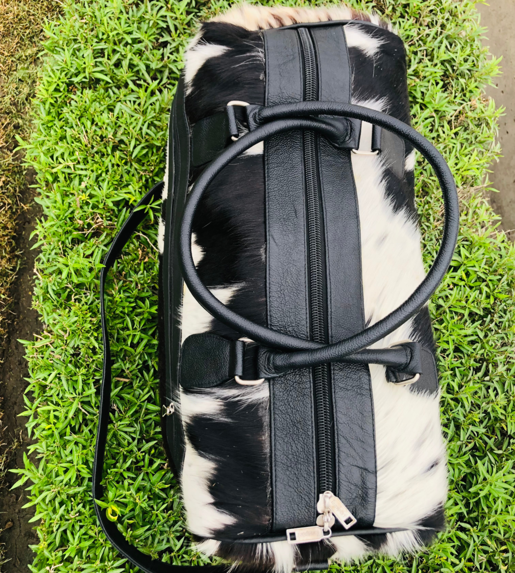 Make a statement with a timeless cow fur weekender bag, your perfect companion for spontaneous getaways.