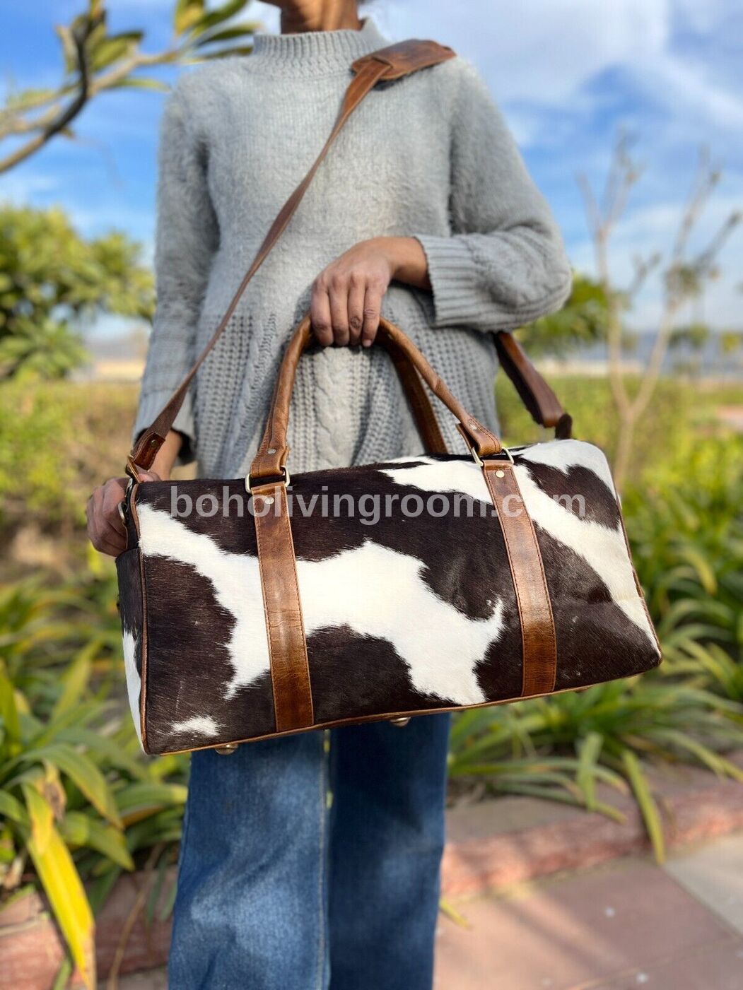 Black, brown, white cowhide duffel for weekend getaways or gym essentials. eye-catching & practical, built to last.
