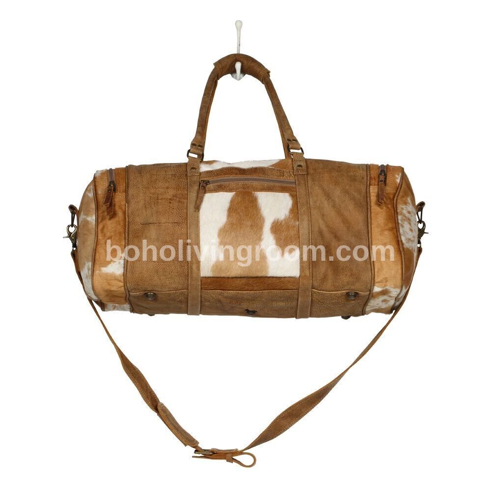 Large cowhide weekender in brown & white. real leather built for adventure. pack light, travel far.