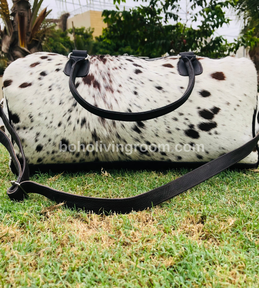  Get ready for your next getaway with our durable cowhide duffle bag. Roomy enough for all your essentials, it's the perfect travel companion.