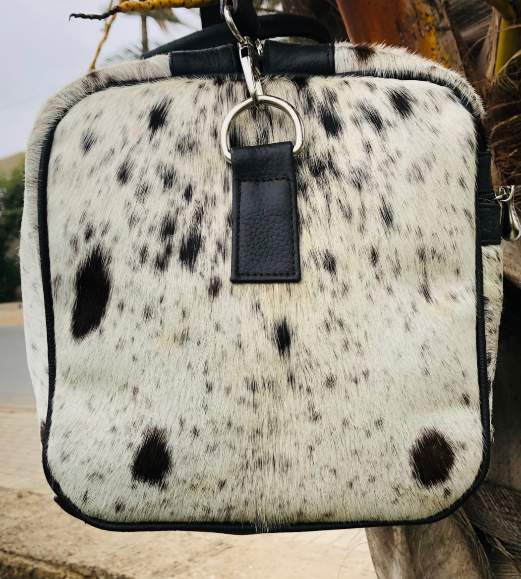 Take on any adventure with our reliable cowhide duffle bag. Designed for durability and comfort, it's the perfect travel solution.