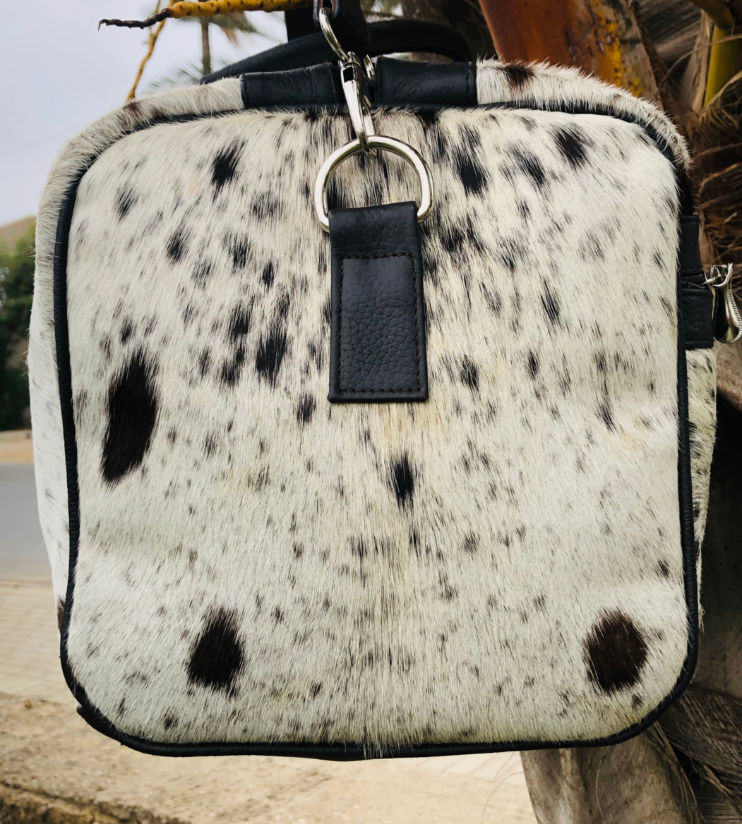  Take on any adventure with our reliable cowhide duffle bag. Designed for durability and comfort, it's the perfect travel solution.