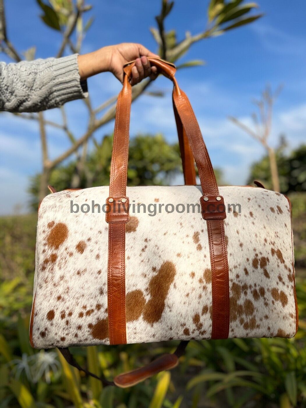 Indulge in luxury travel with a stylish cow fur overnight bag, your essential companion for indulgent trips.