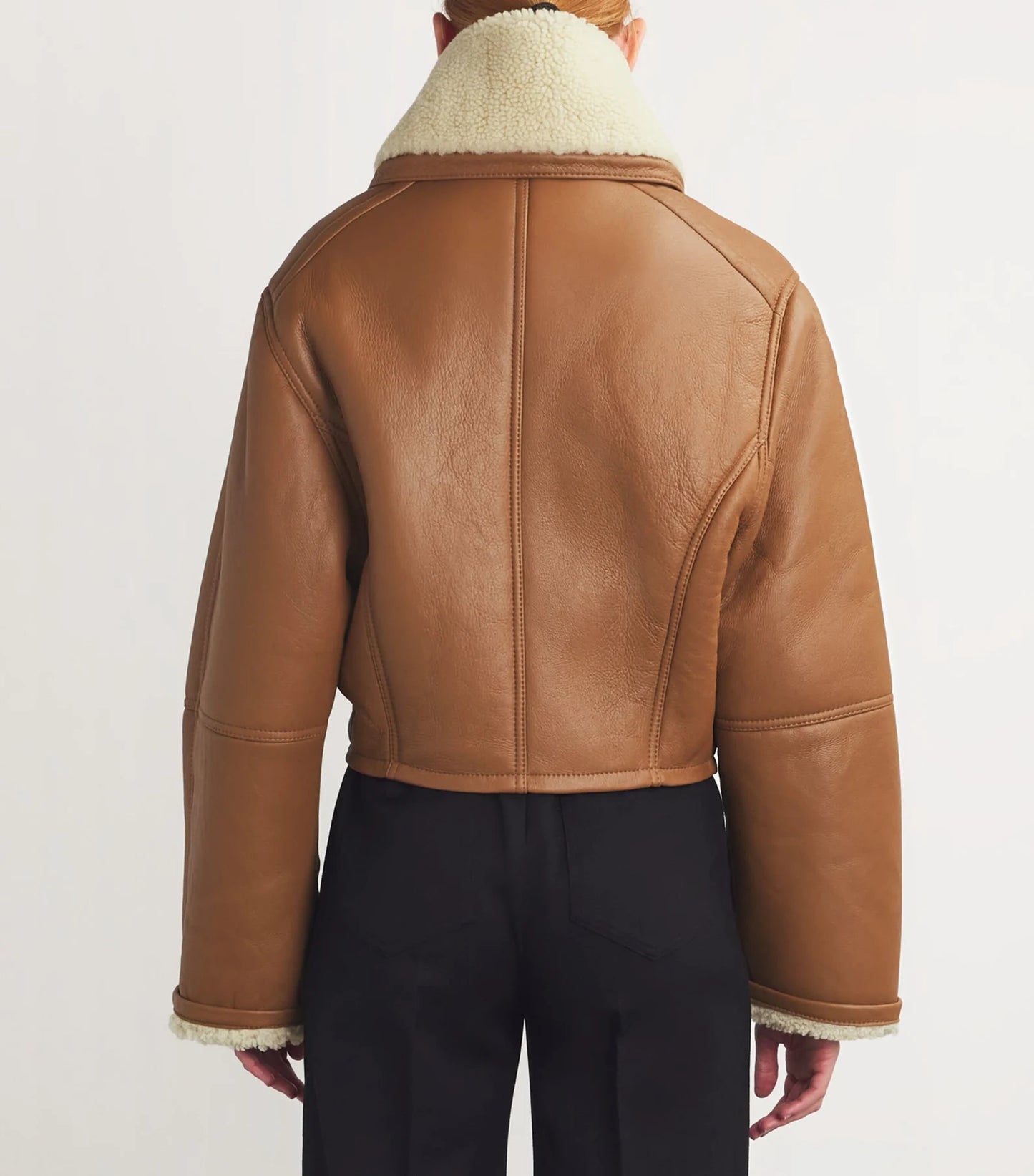 Modern genuine leather coat laid flat, emphasizing its sleek design, durable material, and polished look.