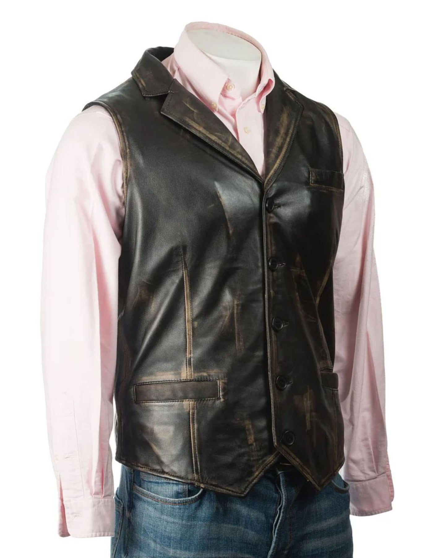 Man in a brown leather waxed vest over a plaid shirt, standing near a rustic wooden background.