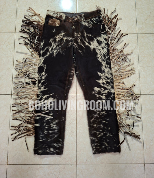 Cowskin pants with fringe made from authentic cow fur. These cowhide trousers offer natural texture, bold Western vibes, and a unique black, brown, white mix.