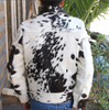 Cowhide coat made from real black and white hair-on-hide. Mens cowhide jacket design includes pockets, button cuffs, and Western-inspired details.