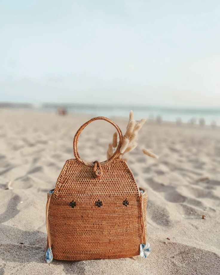 Close-up of a handwoven rattan bag in golden brown.