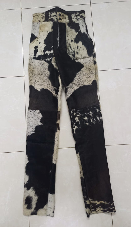 Hair on cowhide pants for women featuring unique black and white patterns. Made from real cow skin with a tailored, structured fit.