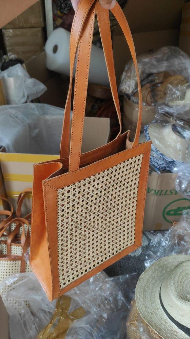 Rattan summer purse made with cowhide leather and cane webbing. A lightweight rattan bag ideal for beach days or everyday carry.